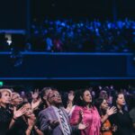 Congregation lifting their hands in praise to God.